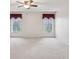 Large carpeted bedroom with two windows letting in ample natural light at 18325 Whitacre Cir, Hudson, FL 34667