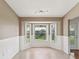 Cozy dining area with natural light from the bay window and updated wainscoting at 18325 Whitacre Cir, Hudson, FL 34667