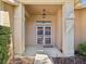Inviting front entrance featuring a screened double door and brick pillar accents at 18325 Whitacre Cir, Hudson, FL 34667