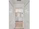 Hallway view of bathroom featuring double sinks, tiled floor, and generous lighting at 18325 Whitacre Cir, Hudson, FL 34667