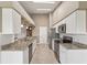 Modern kitchen featuring white cabinets, stainless steel appliances, and beautiful granite countertops at 18325 Whitacre Cir, Hudson, FL 34667