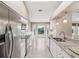Updated kitchen showcasing stainless steel appliances, granite counters, and ample cabinet space at 18325 Whitacre Cir, Hudson, FL 34667