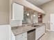 A bright kitchen with granite countertops, updated appliances, and white cabinets at 18325 Whitacre Cir, Hudson, FL 34667