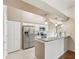 Bright kitchen featuring stainless steel refrigerator and granite countertops and breakfast bar at 18325 Whitacre Cir, Hudson, FL 34667