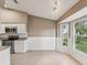 Kitchen nook featuring a bright view, white cabinets, and modern appliances at 18325 Whitacre Cir, Hudson, FL 34667