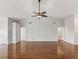 Spacious living room featuring hardwood floors, vaulted ceilings, and a ceiling fan at 18325 Whitacre Cir, Hudson, FL 34667