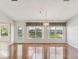 Bright living room featuring hardwood floors, large windows, and elegant chandelier at 18325 Whitacre Cir, Hudson, FL 34667