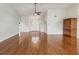 Spacious living room with hardwood floors leading to the entryway and featuring vaulted ceilings at 18325 Whitacre Cir, Hudson, FL 34667