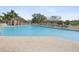 A large and inviting outdoor swimming pool with lounge chairs and a view of the surrounding community at 18325 Whitacre Cir, Hudson, FL 34667