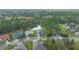 Aerial view of a single-story home with pond and lush green landscaping in a quiet community at 19770 Tattnall Way, Brooksville, FL 34601