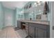 Elegant bathroom features double sinks, granite countertops, vanity seating, and tiled flooring at 19770 Tattnall Way, Brooksville, FL 34601