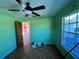 View of a bedroom featuring a ceiling fan, natural light, and geometric-patterned flooring at 2953 Oak St, Sarasota, FL 34237