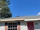 Exterior view of house with a red door, a window with black shutters, and the house number 2953 at 2953 Oak St, Sarasota, FL 34237