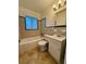 Bathroom with a tub, toilet, and sink, featuring tiled walls and floors at 301 Longwood Dr, Brooksville, FL 34601