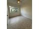 Bedroom features a ceiling fan, one window, and terrazzo flooring at 301 Longwood Dr, Brooksville, FL 34601