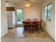 Cozy dining area with classic table set near kitchen and door to outside at 301 Longwood Dr, Brooksville, FL 34601