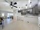 Open concept kitchen with gray cabinetry, modern lighting, and stainless steel microwave at 330 83Rd Ave Ne, St Petersburg, FL 33702