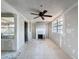 Living room featuring a ceiling fan and fireplace for a cozy atmosphere at 330 83Rd Ave Ne, St Petersburg, FL 33702