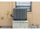 Close-up of an air conditioning unit on a concrete base next to a window at 3403 Holly Springs Dr, Hernando Beach, FL 34607
