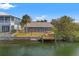 Backyard of waterfront home with dock, seawall, and screened in back porch at 3403 Holly Springs Dr, Hernando Beach, FL 34607