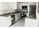 Well-lit kitchen with modern appliances, granite countertops, and ample white cabinetry at 3403 Holly Springs Dr, Hernando Beach, FL 34607