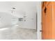 Open floor plan featuring living room and kitchen areas with light tile flooring for easy maintenance at 3403 Holly Springs Dr, Hernando Beach, FL 34607