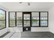 Sunroom with large windows offering stunning lake views and plenty of natural light at 3403 Holly Springs Dr, Hernando Beach, FL 34607