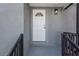 View of the front porch with a white front door and a modern light fixture at 4148 Fairfield S Ave, St Petersburg, FL 33711