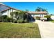 Charming single-story home featuring a well-maintained lawn, lush shrubbery and a long driveway at 4295 Tahiti Dr, Hernando Beach, FL 34607