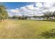 Expansive backyard with a white fence and grassy lawn offers ample space for outdoor activities at 4412 Caliquen Dr, Brooksville, FL 34604