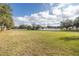 Vast backyard with a white fence and manicured lawns, perfect for outdoor activities at 4412 Caliquen Dr, Brooksville, FL 34604