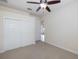 Bedroom featuring a ceiling fan and a large closet with sliding doors at 4412 Caliquen Dr, Brooksville, FL 34604