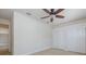 Bedroom featuring a ceiling fan, carpet, double-door closet, and neutral paint at 4412 Caliquen Dr, Brooksville, FL 34604