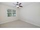 Bedroom featuring a ceiling fan and a large window with blinds at 4412 Caliquen Dr, Brooksville, FL 34604