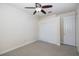 Bedroom with ceiling fan, carpet, and large closet with sliding doors at 4412 Caliquen Dr, Brooksville, FL 34604
