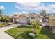 Well-maintained home featuring a brick driveway, stone accents, lush lawn and blue sky at 4412 Caliquen Dr, Brooksville, FL 34604