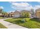 Well-maintained home featuring a brick driveway, stone accents, lush lawn and blue sky at 4412 Caliquen Dr, Brooksville, FL 34604
