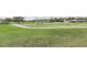 Picturesque golf course with smooth green grass, a winding concrete path, and houses in the distance at 4412 Caliquen Dr, Brooksville, FL 34604