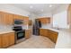Well-lit kitchen with stainless steel appliances and oak cabinetry at 4412 Caliquen Dr, Brooksville, FL 34604