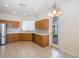 Bright kitchen with wooden cabinets, stainless steel appliances, and an eat-in area with backyard access at 4412 Caliquen Dr, Brooksville, FL 34604