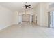 Open-concept living area with tile floors, high ceilings, and access to the dining room and backyard at 4412 Caliquen Dr, Brooksville, FL 34604