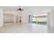 Bright and airy living room with tile flooring, slider access to backyard, and decorative lighting at 4412 Caliquen Dr, Brooksville, FL 34604