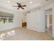 Main bedroom with carpet flooring, ceiling fan, and en-suite bathroom at 4412 Caliquen Dr, Brooksville, FL 34604