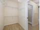 Spacious walk-in closet with wire shelving and access to the bathroom at 4412 Caliquen Dr, Brooksville, FL 34604