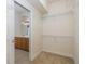 Walk-in closet with wire shelving and view into a vanity area at 4412 Caliquen Dr, Brooksville, FL 34604