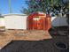 View of a backyard area with multiple sheds, including a weathered metal shed and additional storage at 4721 Del Rio S Way, Gulfport, FL 33711