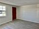 Bright bedroom with a window and gray hardwood flooring at 4930 Getner St, New Port Richey, FL 34652