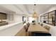 Bright dining room with wood table, stylish lighting, and a decorative mirror to enhance the space at 5015 Us Highway 19 # 101, New Port Richey, FL 34652