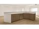 Kitchen island with bar seating, wooden cabinets, and open layout, great for entertaining guests at 5015 Us Highway 19 # 108, New Port Richey, FL 34652