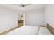 Clean bedroom with white walls, hardwood floors, and a view into a dining room at 5015 Us Highway 19 # 303, New Port Richey, FL 34652